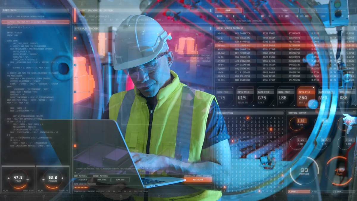 Computer engineer working with a computer interface in a factory.