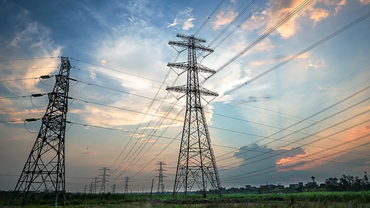 Electricity Pylon power line transmission tower at sunset