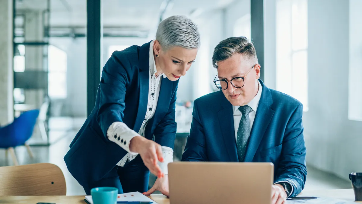 Two lawyers looking at legal technology on a laptop