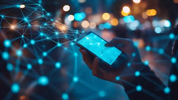 Hand holding a smartphone with digital network connections