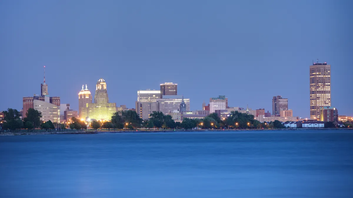 A view across the water looking at the skyline of Buffalo, New York at dusk during blue hour.