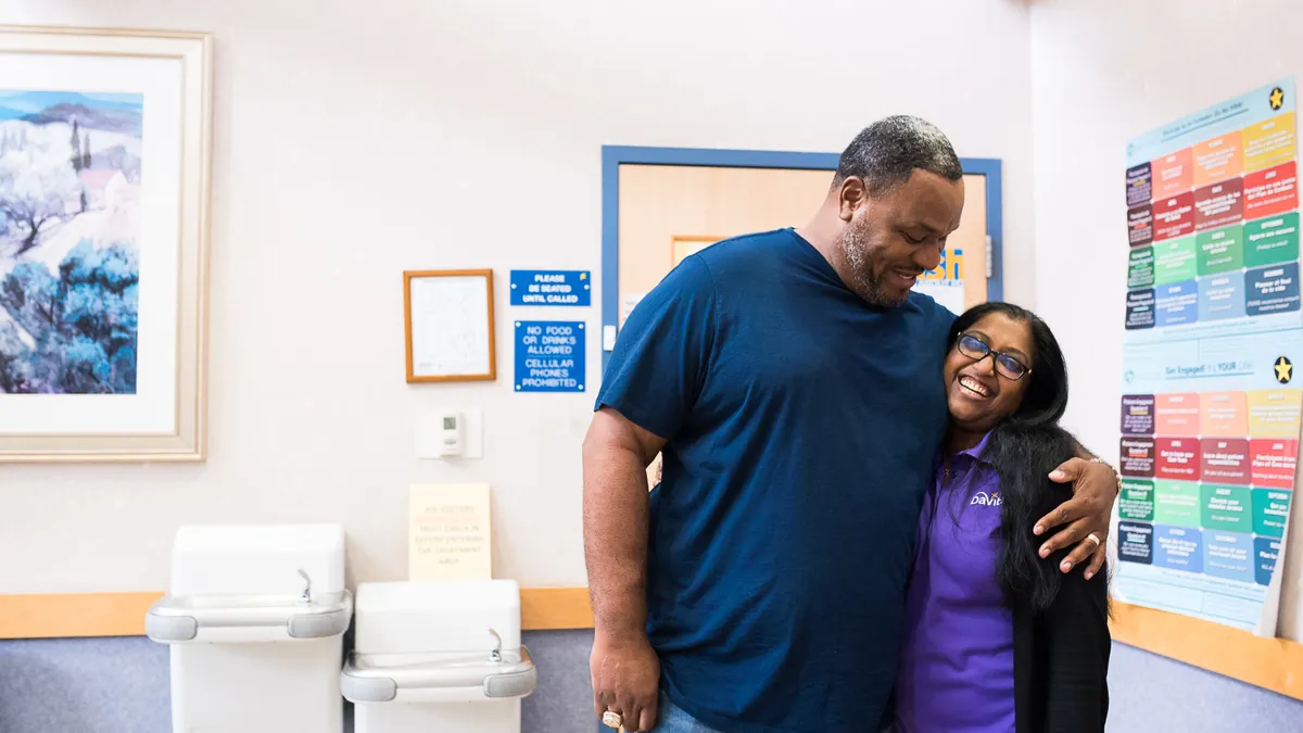 DaVita worker hugging a patient