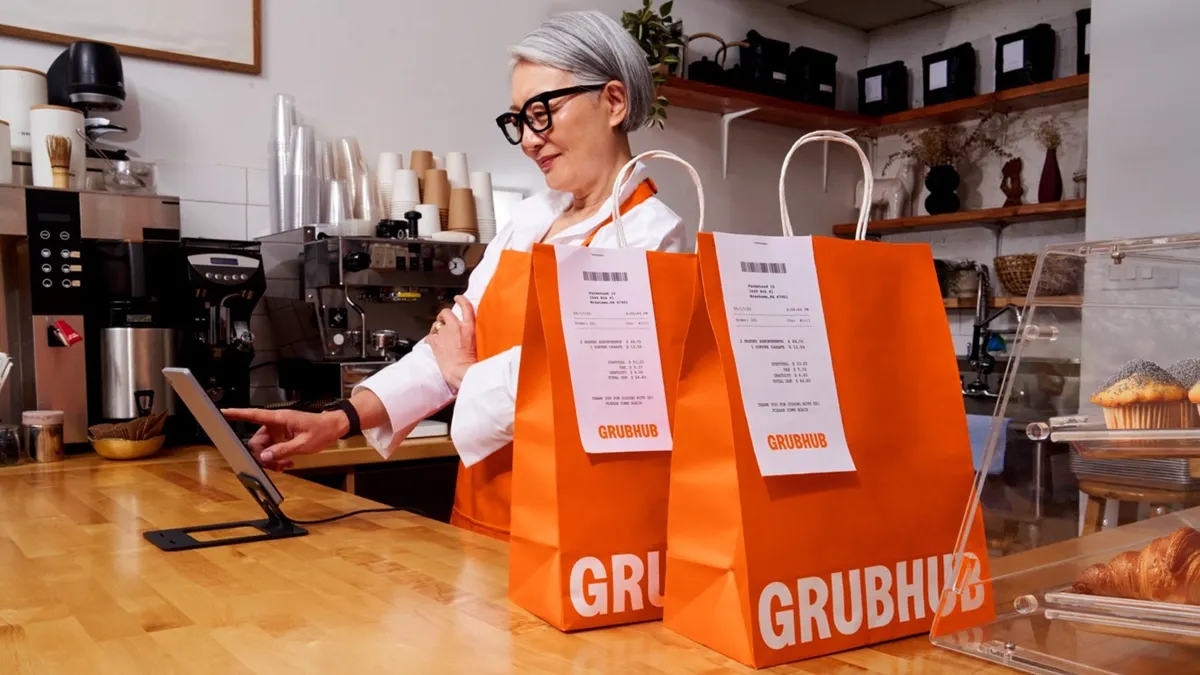 Grubhub food delivery bags on the counter at a coffee shop.