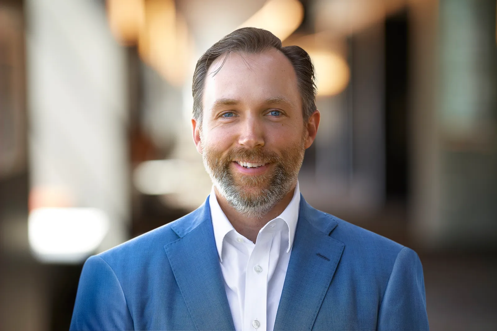 Man in blue suit jacket and white shirt.