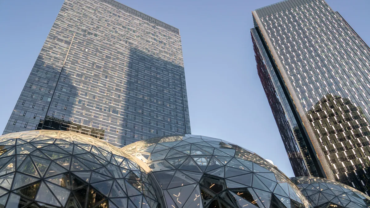 Large office buildings against a blue sky.