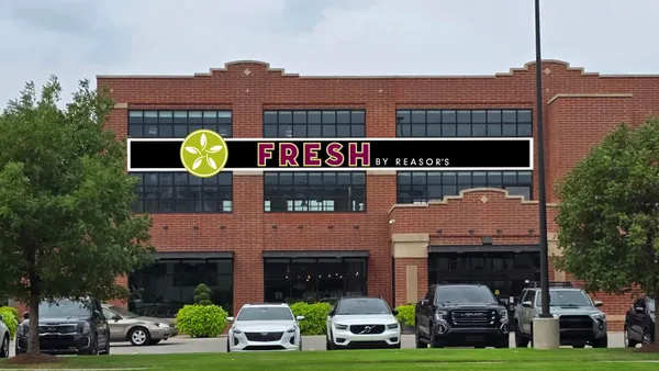 Exterior of a red brick building with a sign that reads "Fresh by Reasor's."