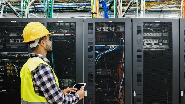 technician man working inside big data center room