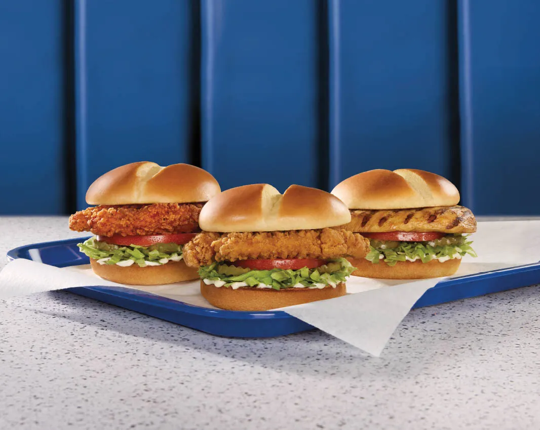 A photograph of three chicken sandwiches