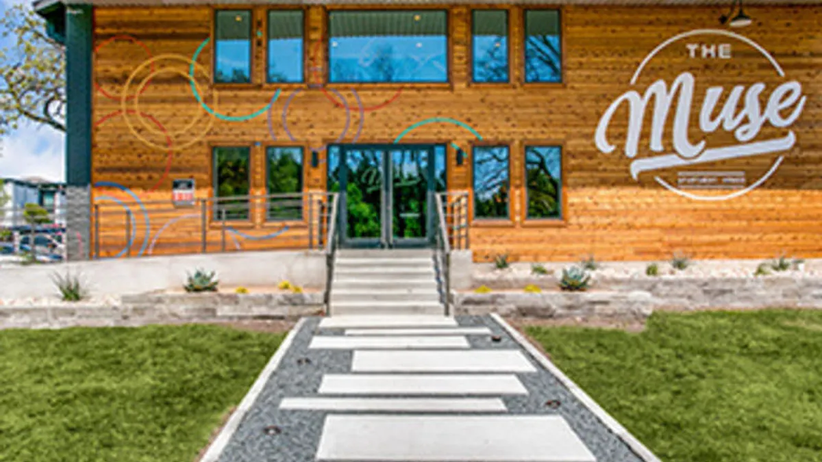 Entrance to an apartment property with the words "The Muse" on the building.