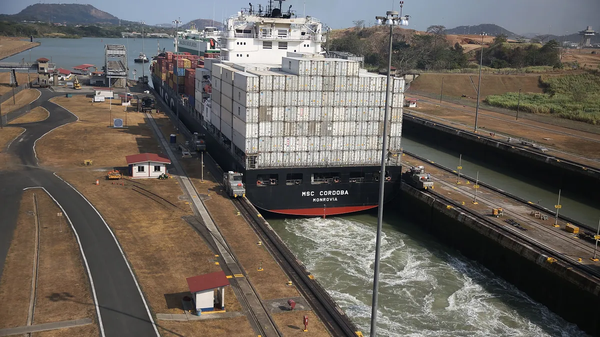 A cargo ship makes its way through the Miraflores locks as it crosses the Panama Canal on April 7, 2016.