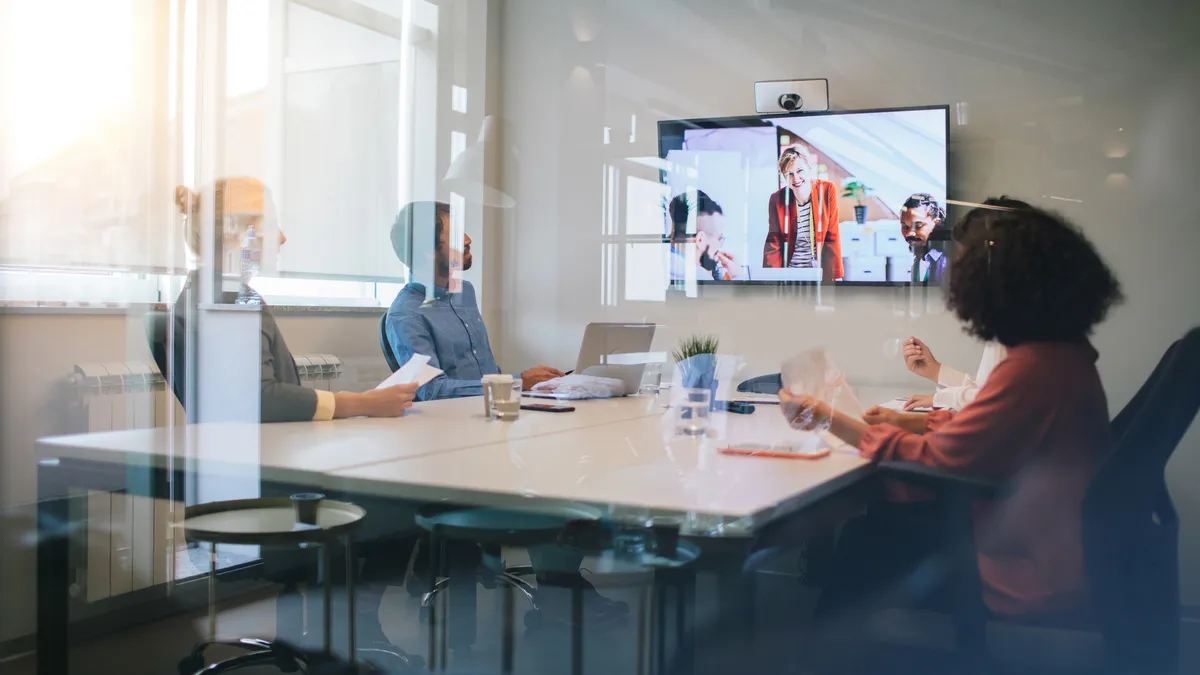 Group of young business people discussing with colleagues on video conference on meeting.