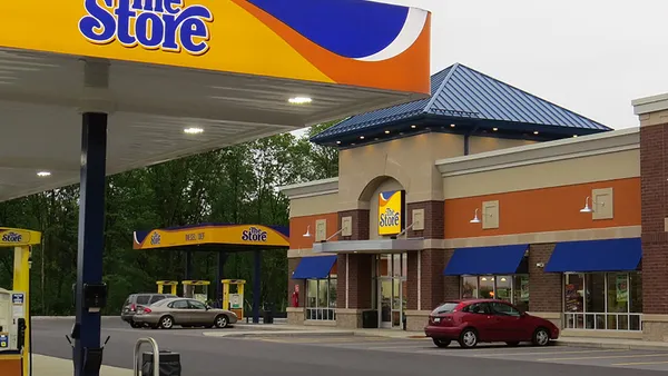 A photo showing the exterior of a convenience store. The fuel canopies, gs pumps and a sign on the store all say "The Store."