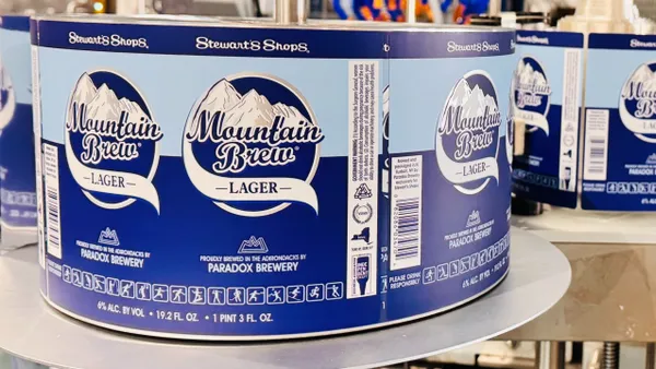 A photo of beer labels on a production line. The labels say "Stewart's Shops Mountain Brew lager. Proudly brewed in the Adirondaks by Paradox Brewery."