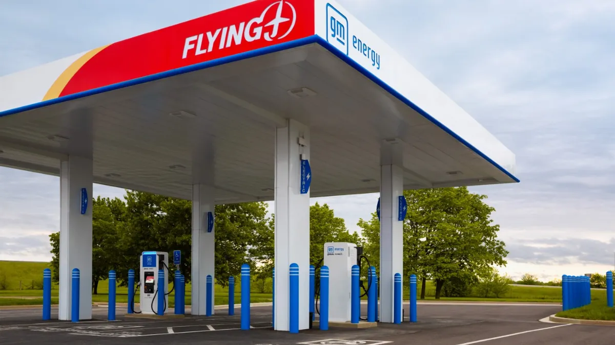 An electric vehicle charging station co-branded by Flying J and GM Energy with the two company logos visible on the overhead canopy