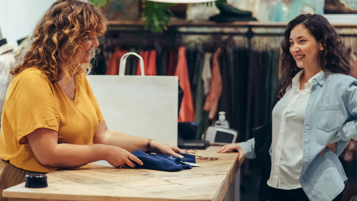 Photo of customer and store rep talking.