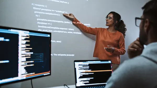 A person teaching students new digital skills in a class setting