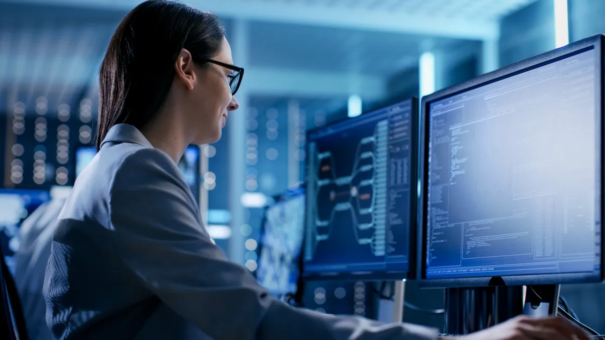 Close-up Shot of Female IT Engineer Working in Monitoring Room.