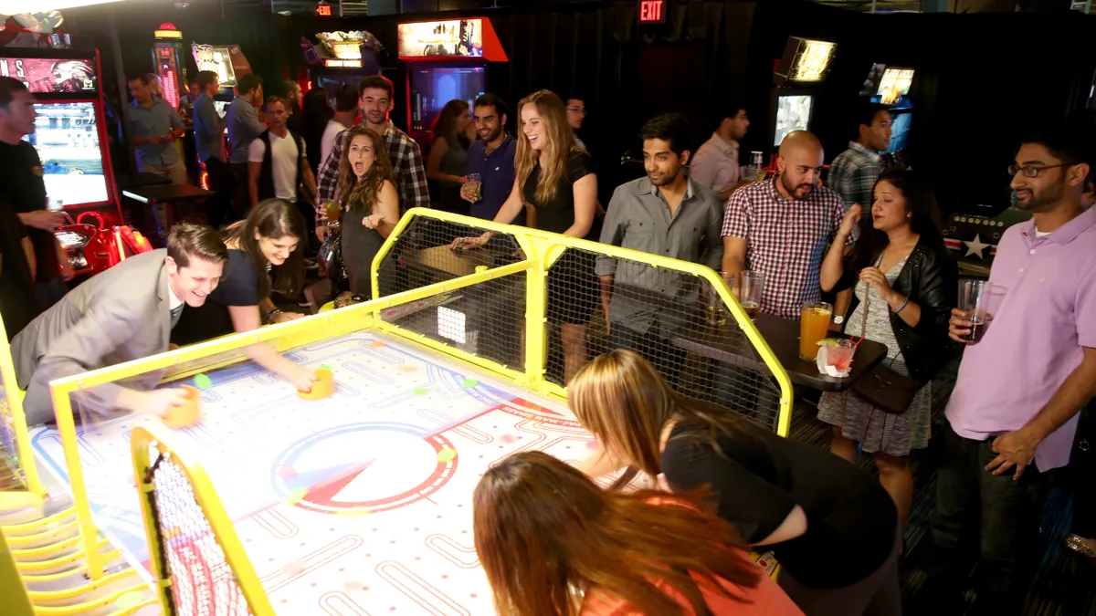 Guests play arcade games at Dave & Buster's.