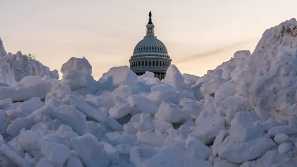 The United States Capitol surrounded by snow.