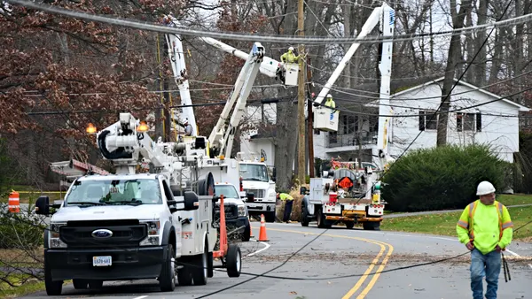 Utility crews repair downed power lines.