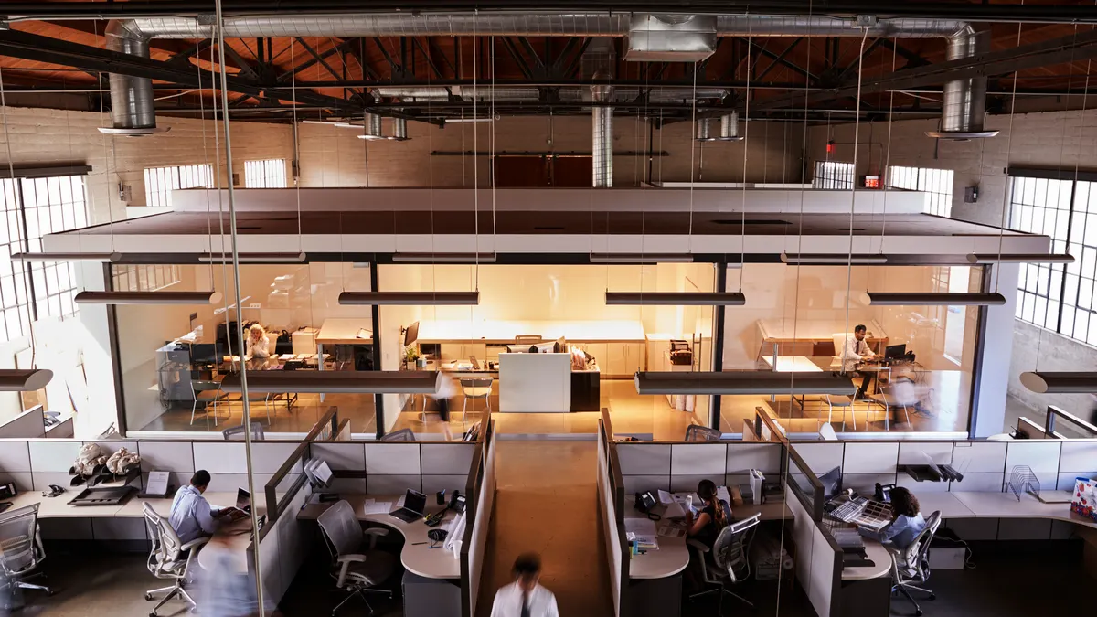Elevated view of staff working in a busy open plan office