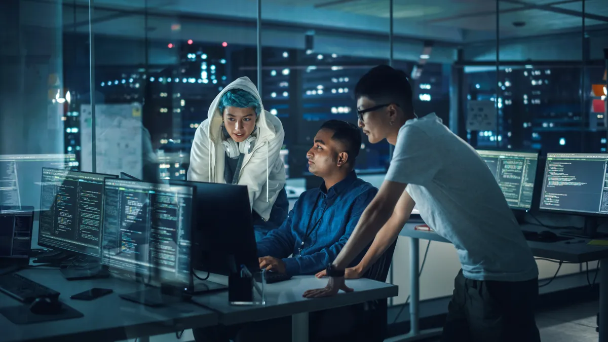 Team of professionals meeting in office around computers