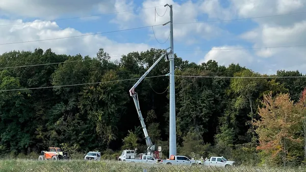 Utility crews work on a transmission line.
