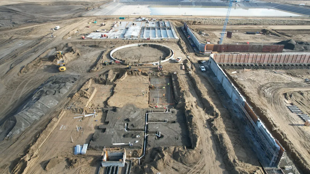 Aerial view of a large industrial construction site in the early stages of development