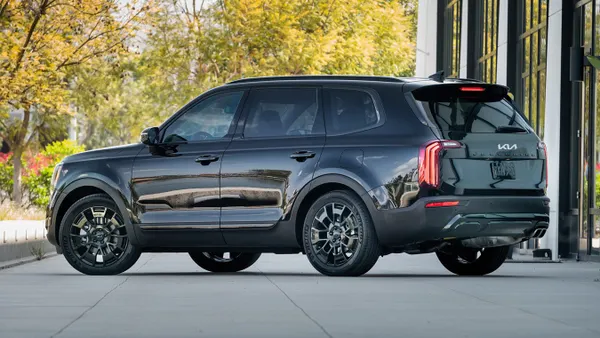 A 2022 Kia Telluride Nightfall Edition SUV parked outdoors with greenery in the background.
