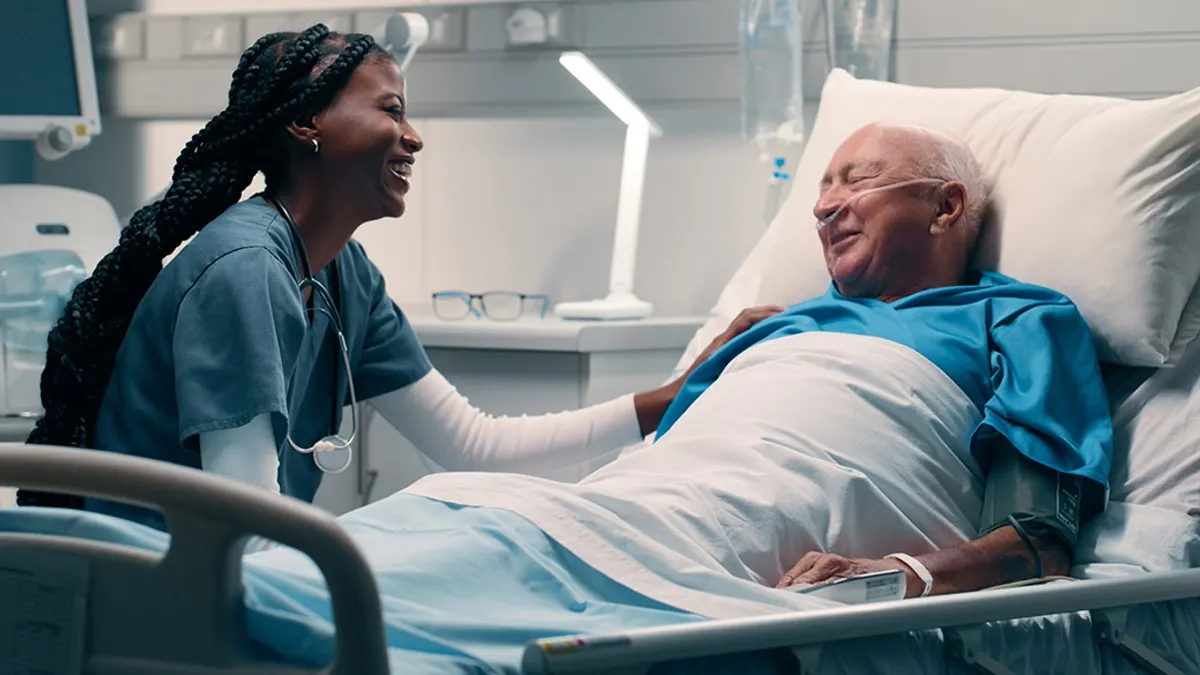 Bed, nurse and smile with patient in hospital for help, support and good news with care.