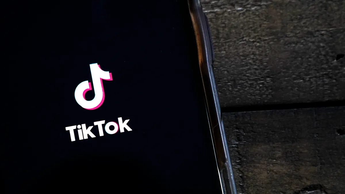 The TikTok logo on a phone.