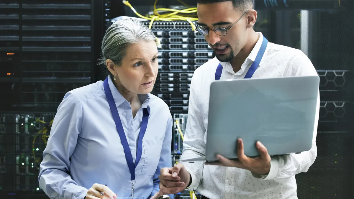 Shot of two technicians working together in a cloud server room