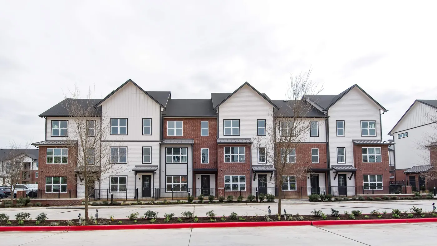 Row of new townhomes with parking in the foreground