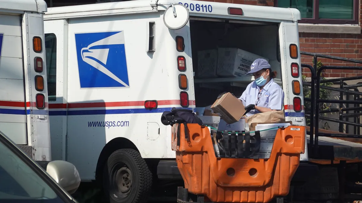 A postal worker loads a delivery truck on October 1, 2021 in Chicago, Illinois.