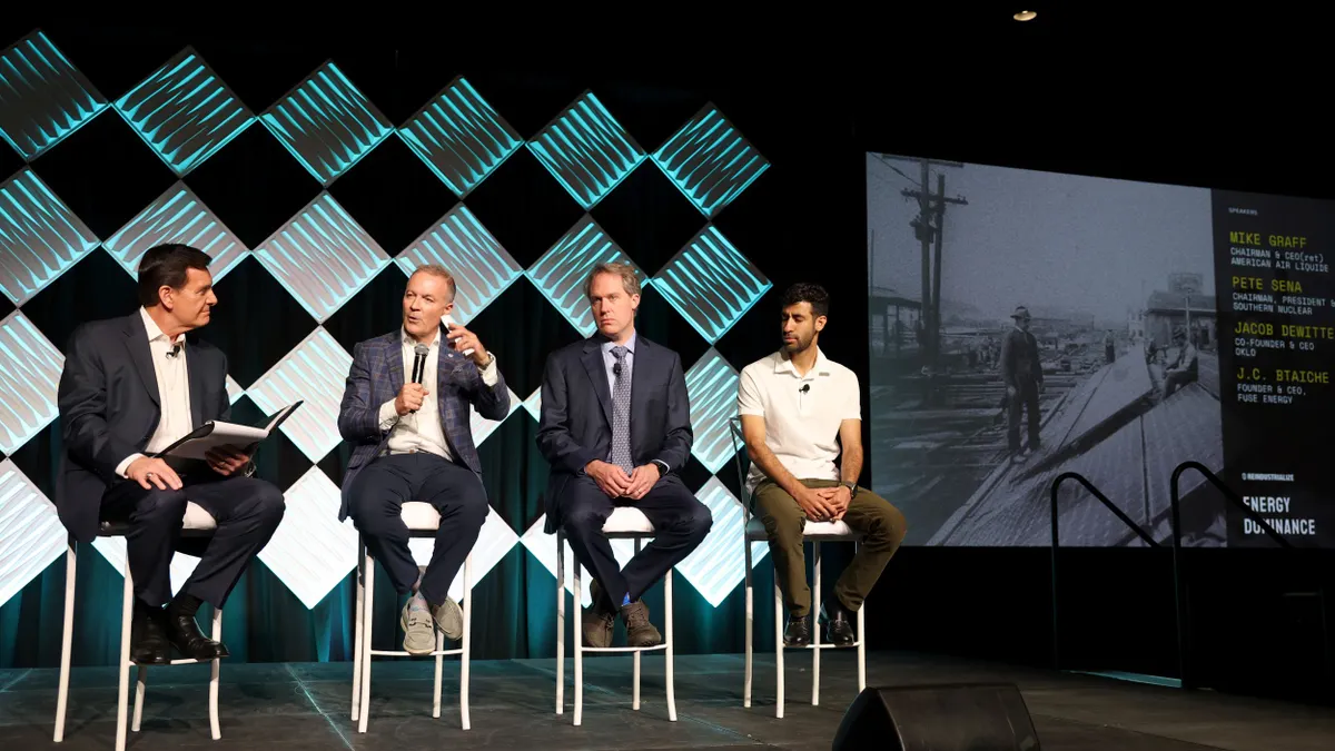 panelists sit on stage