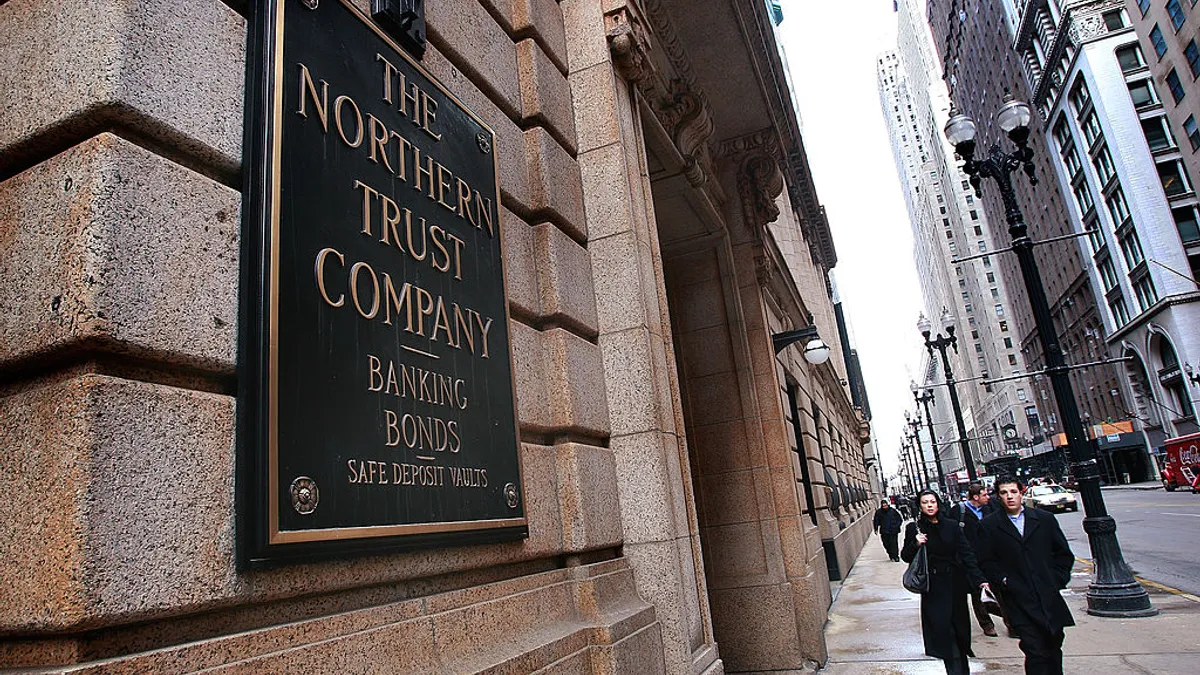 Pedestrians seen walking by the Northern Trust banking company's headquarters.