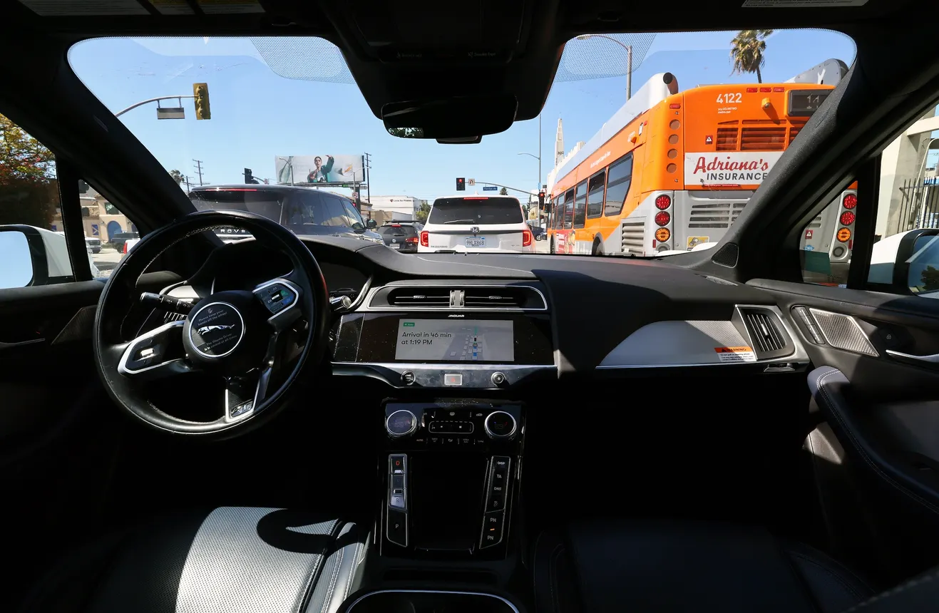 View from the back seat of a self-driving car amid heavy traffic.