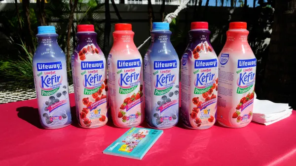 Bottles of Lifeway Kefir stand next to each other on a table.