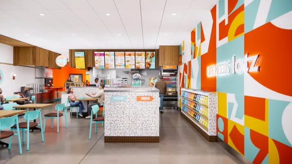 An image of an interior restaurant with a order lane and seating area and orange, blue and white decor