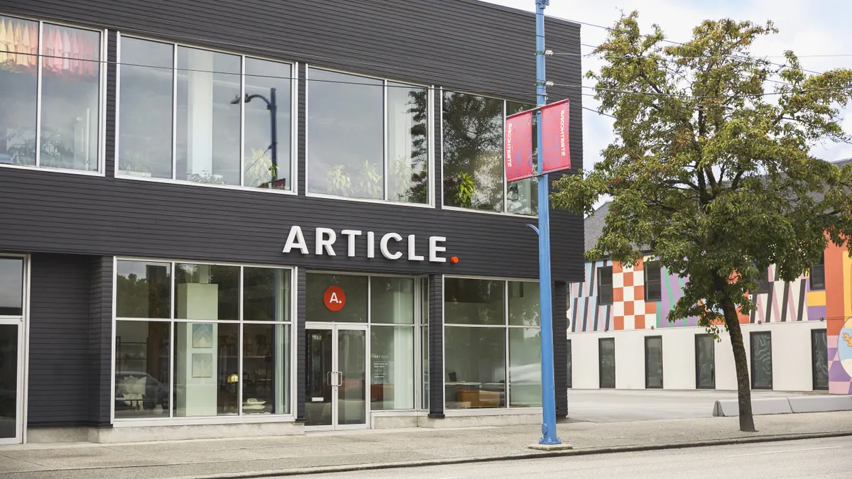 A gray storefront with the word "Article" on the front.