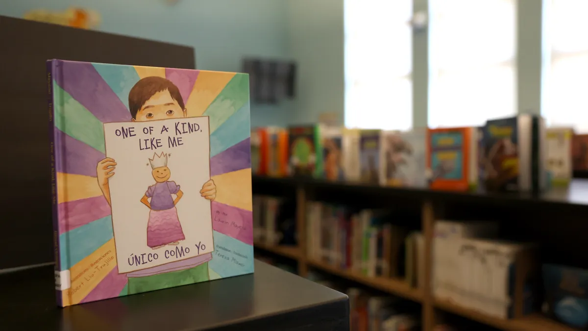 A book titled "One Of A Kind, Like Me" sits on a bookshelf in California