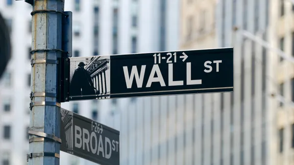 A street sign marks the intersection of Wall and Broad Streets in Manhattan.