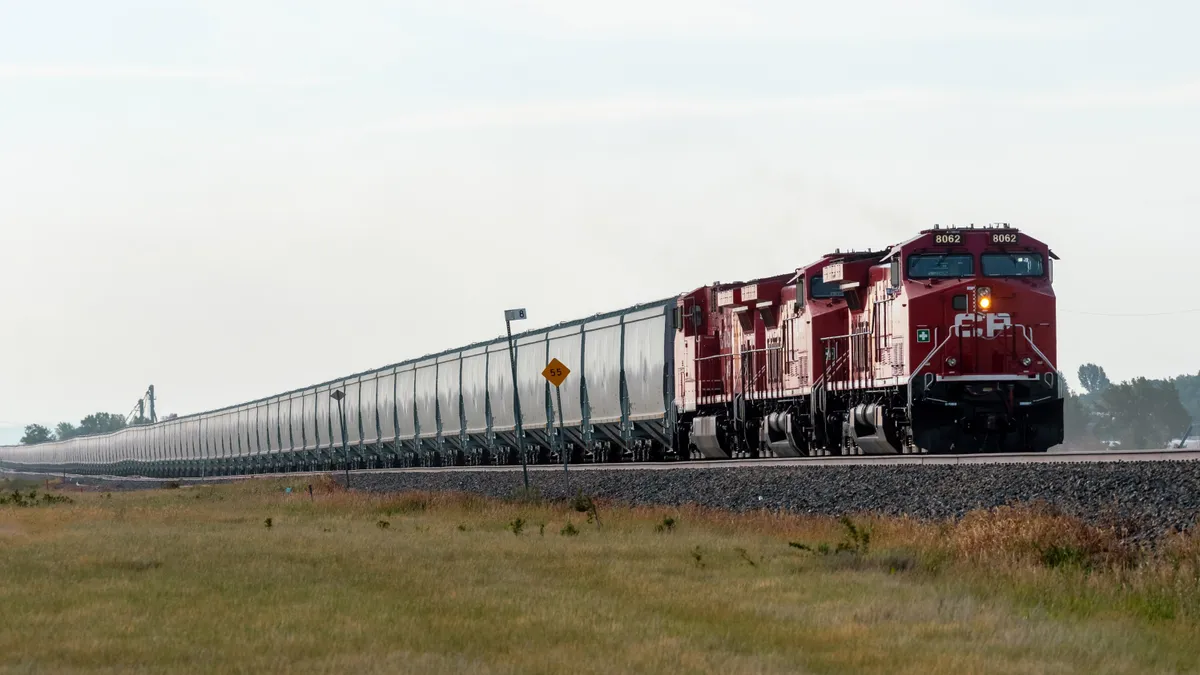 A Canadian Pacific train carrying grain on the tracks.