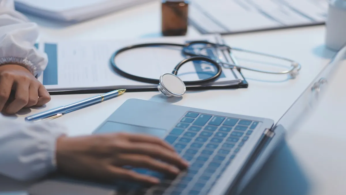 Medical professional working on a laptop
