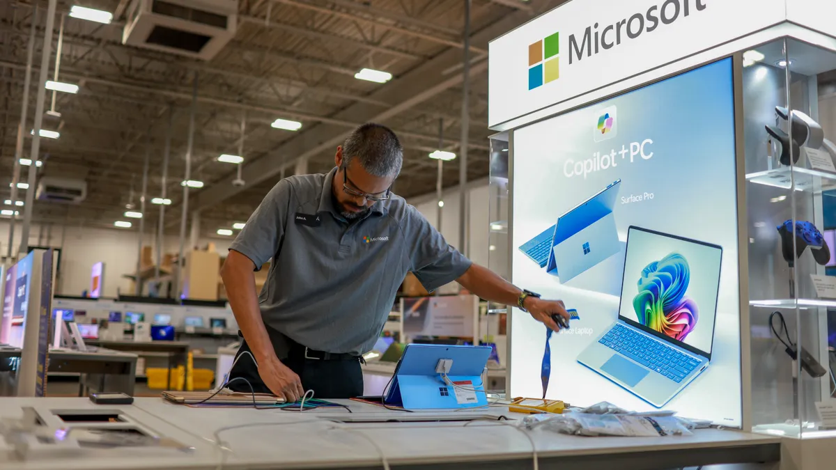 A person sets up a display of computer.