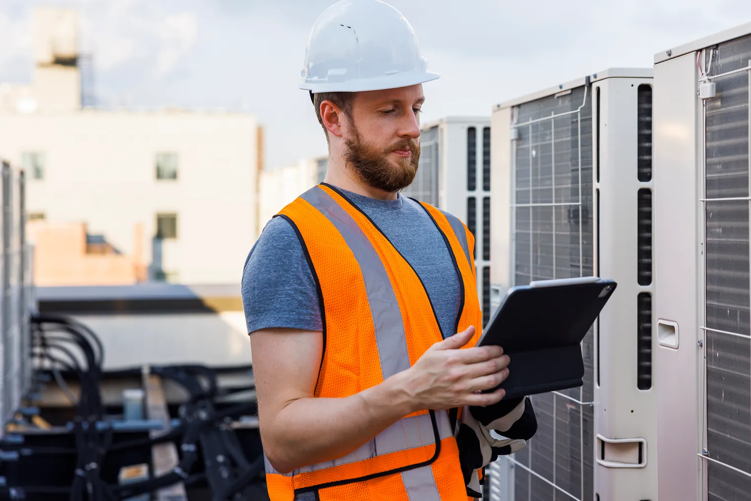 A technician checks the air conditioning system, using a portable computer.