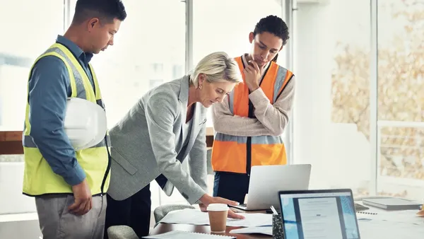 Construction workers in an office meeting