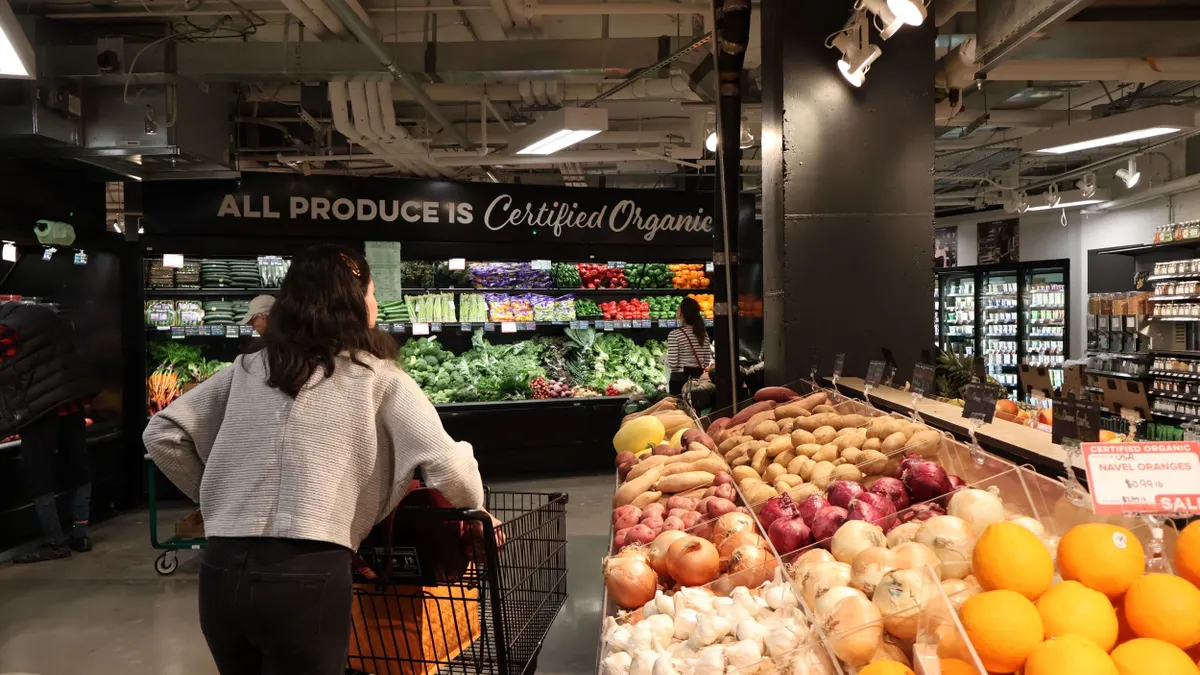 Woman shopping for produce in grocery store