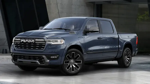 The 2026 Ram 1500 REV Tungsten parked in front of concrete wall,