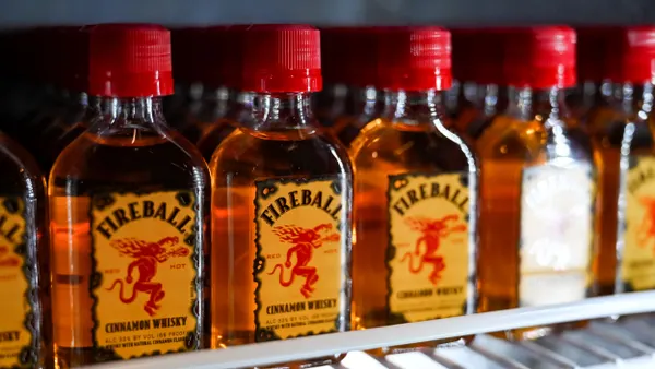 Mini bottles of Fireball are displayed on a shelf.